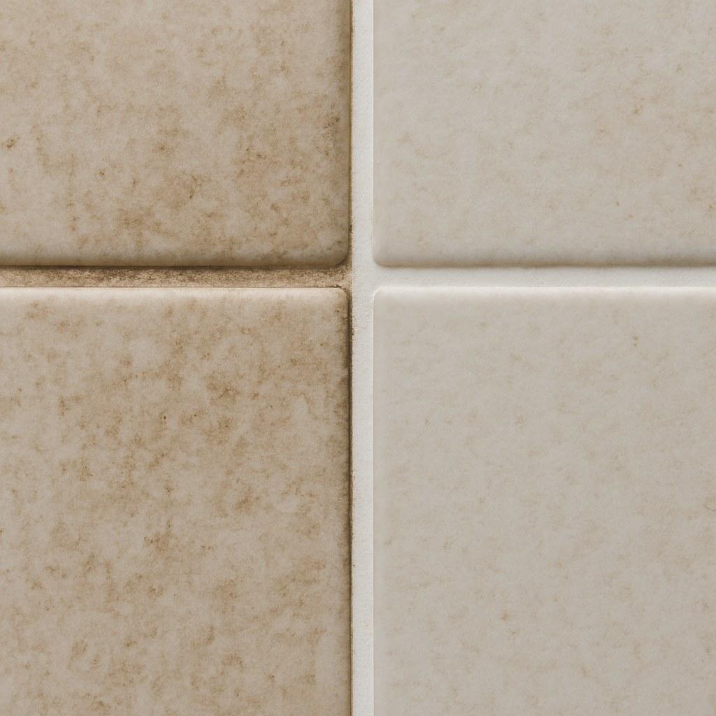 A before and after comparison of stained tile grout and clean tile grout