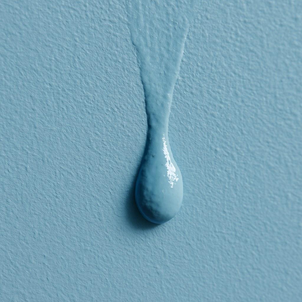 A noticeable paint drip on a newly painted wall.